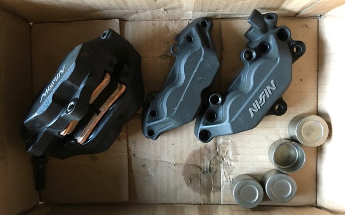 Old calipers, new seals, new pads, and a lot of brake cleaner and scrubbing...